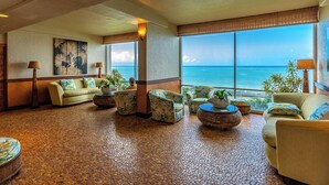 A spacious lobby with a large view of the ocean, a tiled floor, and several seating areas with plants. - Oceanfront Maui condo w/ lanai and pool access (Lahaina)