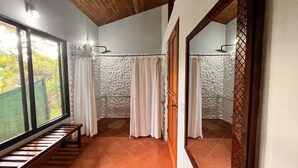 A bathroom with a shower, a bench, and a window. - Blue Banyan Inn (Naranjito)