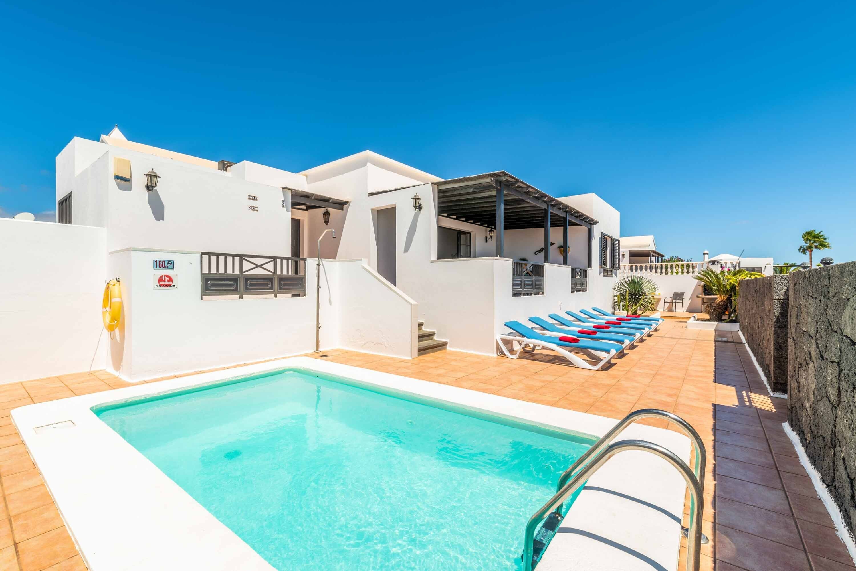 A heated pool, sun loungers