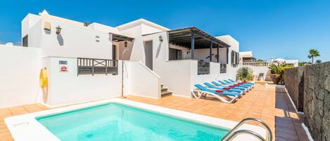 A heated pool, sun loungers