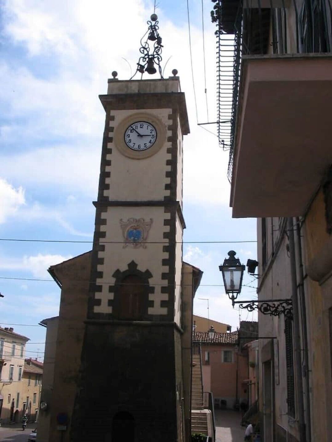 A clock tower with a traditional design, featuring a clock face and a decorative element at the top.