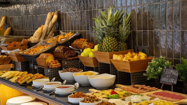 A buffet with various food items including bread, fruits, cheeses, and meats. - Best Western Plus Casablanca City Center (Casablanca)