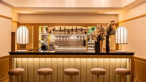 A bar area with a counter, bar stools, and a wine display. - Best Western Plus Casablanca City Center (Casablanca)