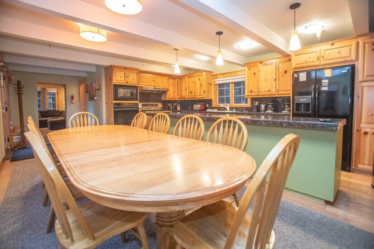 A spacious kitchen with wooden cabinets, a large island, and modern appliances.