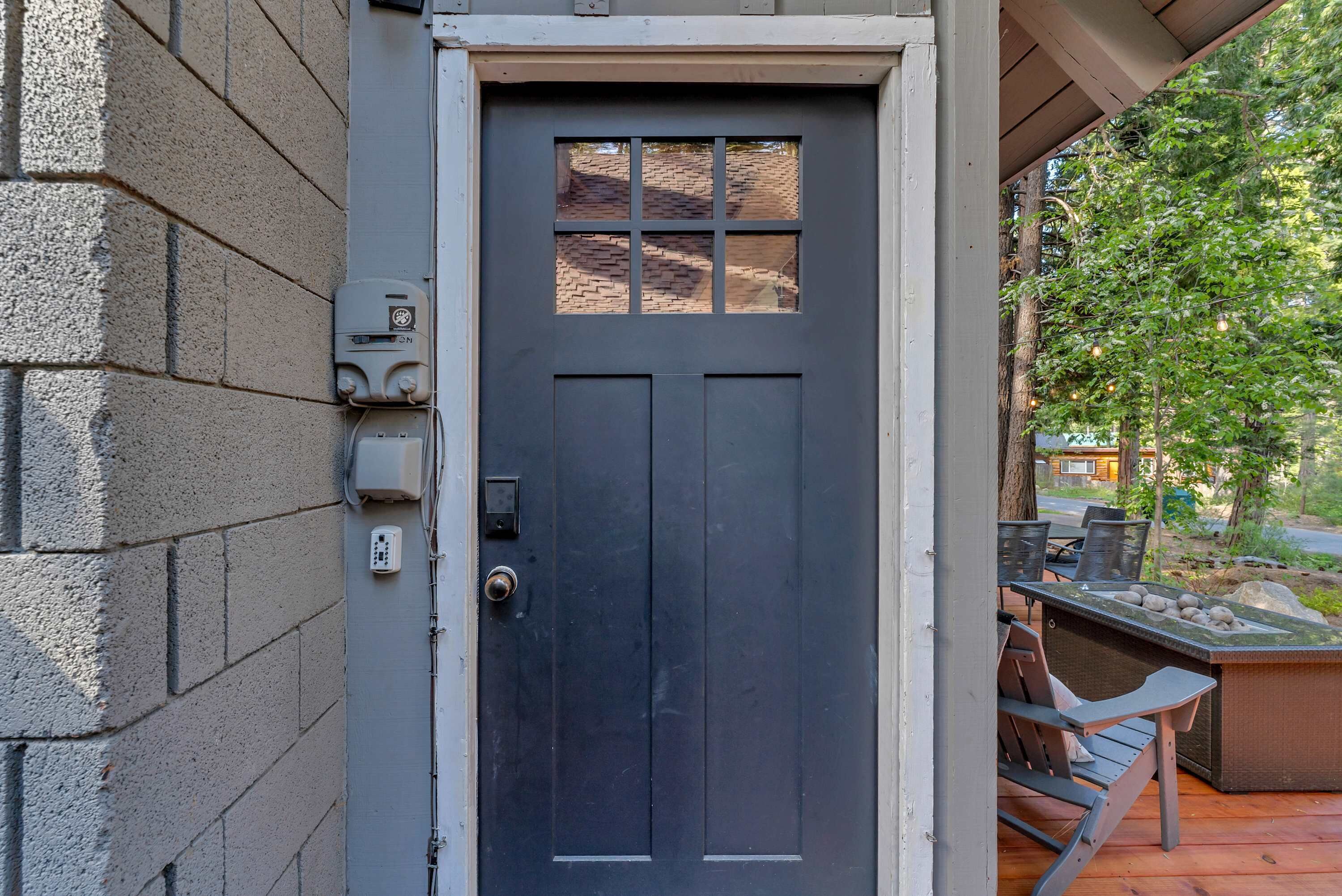 A dark gray door with a window, a keypad, and a lock.