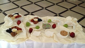 A table with various food items and bowls arranged on a white tablecloth. - Hotel Khanaka (Turkestan)
