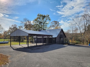 A rustic cabin with a metal roof and a covered porch area.