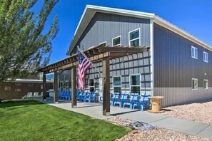 Enjoy the covered patio with a pergola and comfortable seating.