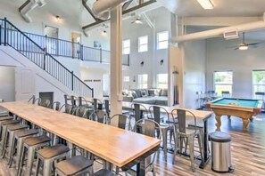 Enjoy communal dining and recreation in this spacious indoor area with a pool table and seating for gatherings.