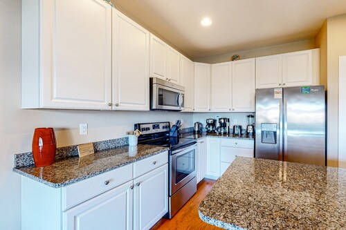 Dog-friendly, water-view townhome with shared pool, patio, grill