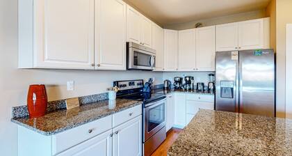 Dog-friendly, water-view townhome with shared pool, patio, grill