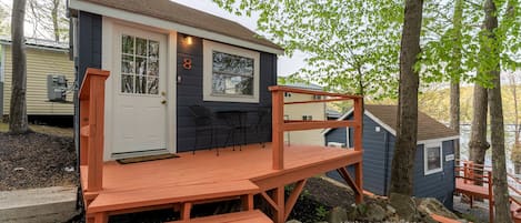A small cabin with a wooden deck and a door marked with the number 8.