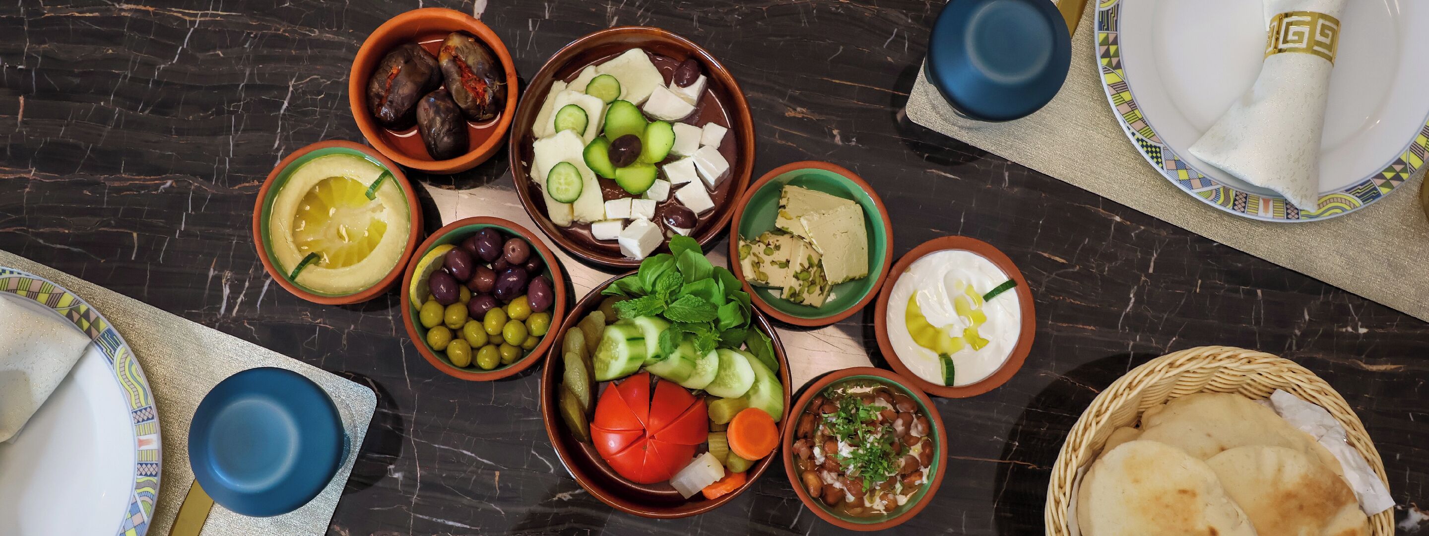 A variety of dishes and food items arranged on a table.