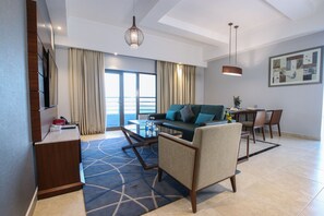 King Suite Seaview With Jacuzzi | Living area | 50-inch LED TV with satellite channels, TV - The Seven Hotel (Manama)