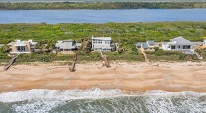 A beachfront property with multiple houses, a sandy beach, and a view of the ocean. - Carpe Beachiem Home, Ocean Views & Dual Decks (Ponte Vedra Beach)