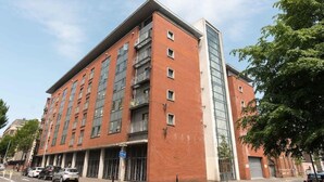 A multi-story building with a red brick facade, large windows, and a modern design. - Best Location in Belfast! Free Parking-Luxury Accommodation (Belfast)