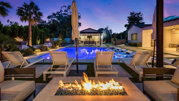 A pool area with lounge chairs, a fire feature, and a covered patio. - Multi-Million $ Resort-Style Estate w/Pickleball (Scottsdale)