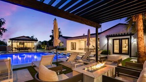 A poolside area with lounge chairs, a fire feature, and a covered patio. - Multi-Million $ Resort-Style Estate w/Pickleball (Scottsdale)