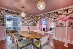 A dining area with a round table, chairs, and a decorative pineapple centerpiece. - Retro FL Charm | Pool + Spa | AMI + Downtown | IMG (Bradenton)