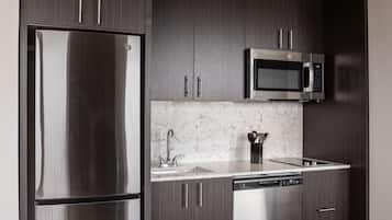 A modern kitchen with a stainless steel refrigerator, a microwave, and a dishwasher.