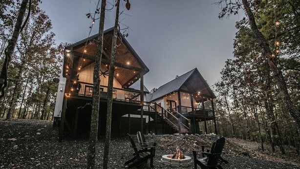 A cabin with a deck, a fire pit, and outdoor seating. - Collins Creek 1 BR- Woodland Hills- 2 acres creek (Broken Bow)
