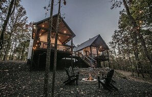 A cabin with a deck, a fire pit, and outdoor seating. - Collins Creek 1 BR- Woodland Hills- 2 acres creek (Broken Bow)