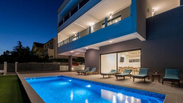 A modern two-story building with a swimming pool and outdoor seating area. - Luxury Villa La nonna Ana - entertainment,fitness,pool,sea view (Kastel Sucurac)