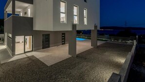 A modern two-story house with a swimming pool, large windows, and a gravel driveway. - Luxury Villa La nonna Ana - entertainment,fitness,pool,sea view (Kastel Sucurac)