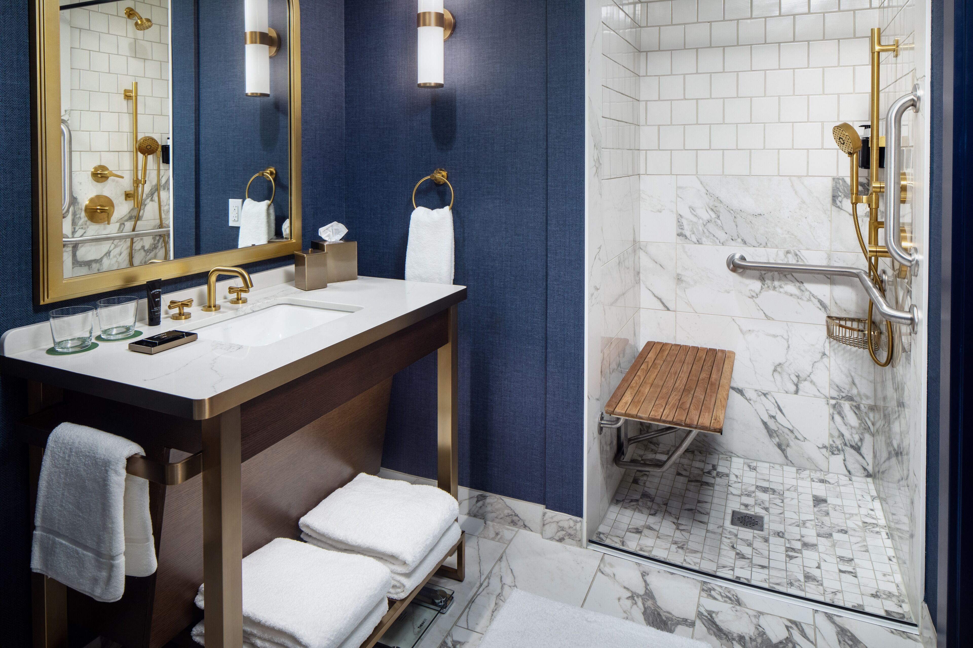 Ein modernes Badezimmer mit einem Waschbecken-Doppelplatz, einer Duschkabine und einer Holzbank.
