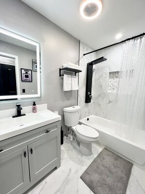 Combined shower/tub, hair dryer, towels, soap