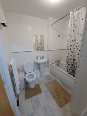 Bathtub, hair dryer, towels, soap