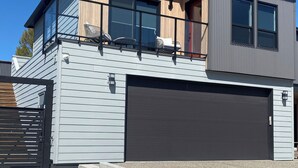 A modern two-story house with a garage, a balcony, and a clear sky. - Wine, Lake, Repeat I City Edge Retreat Naramata Wine Gateway (Penticton)
