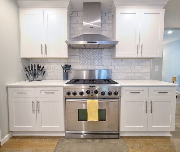 Kitchen features a double oven, range with hood, microwave, and ample countertop space.