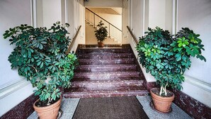 A grand staircase with a marble finish, flanked by two large potted plants. - 1 bedroom lovely apartment in Recco (Recco)
