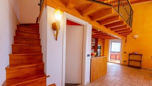 A wooden staircase leading to a second-floor balcony with a railing. - Viganello Panoramica (Lugano)