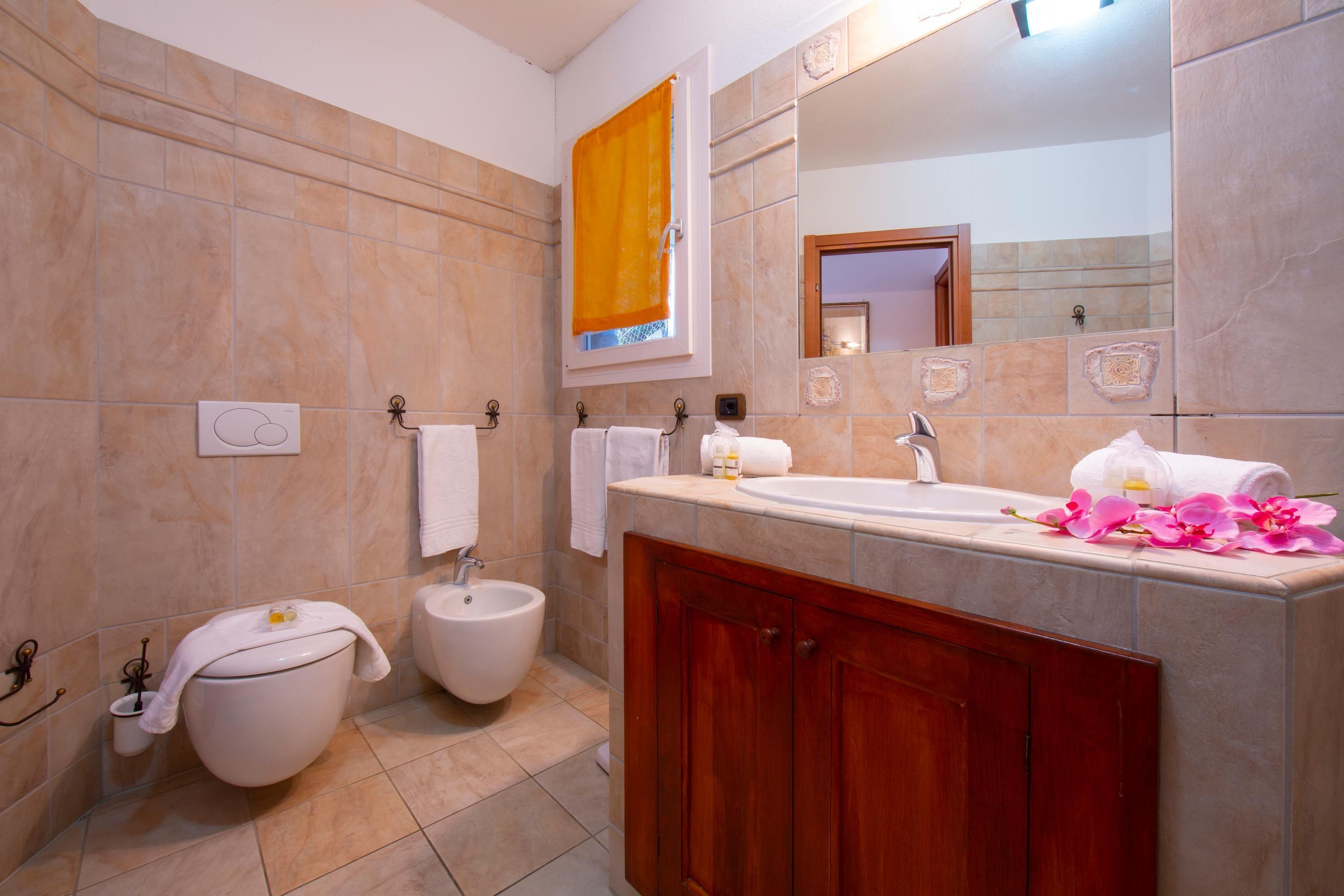 A bathroom with a bathtub, a toilet, and a bidet.