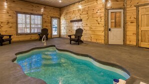 A wooden cabin interior with a pool, two chairs, and a door labeled "The Bath". - Sun Splash #342 (Sevierville)
