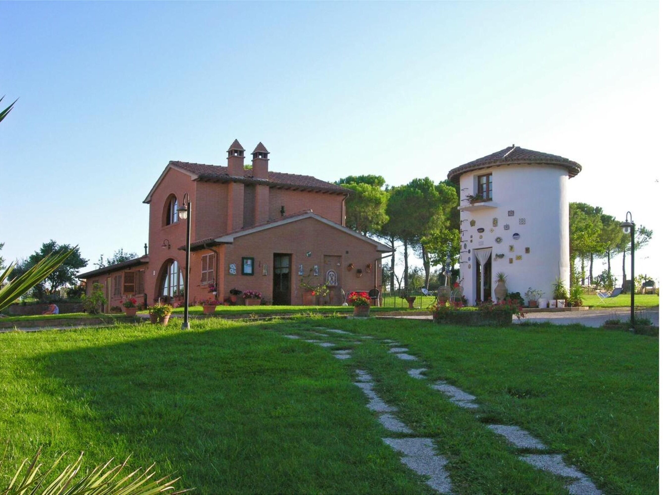 A traditional building with a brick facade and a cylindrical tower.