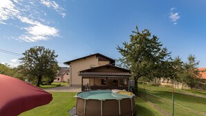 A residential property with a swimming pool, a covered patio, and a house with a sloped roof. - Pool House Mr ek Family Friendly (Bloke)