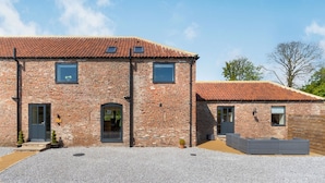 A two-story brick building with a tiled roof, a gravel driveway, and a small garden area. - Partridge Place (Hull)