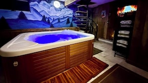 A hot tub with wooden panels, a mural of a night scene, and a shelf with bottles. - Storybook Chalet/Watch Movies Under the Stars/NEW Hot Tub/Hiking/Biking/Concerts (Beech Mountain)