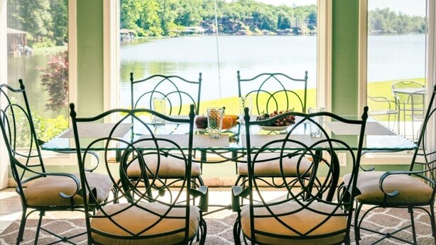 A dining area with a table and chairs facing a lake view. - Soothe Your Soul Lakeside on Beautiful Lake Balboa (Hot Springs Village)
