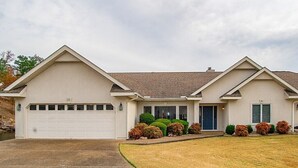 A two-story house with a garage, a front porch, and a well-maintained lawn. - Soothe Your Soul Lakeside on Beautiful Lake Balboa (Hot Springs Village)
