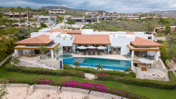 A large, modern resort with multiple buildings, a central swimming pool, and lush landscaping. -  Gorgeous estate in Puerto Los Cabos golf and beach community (San José del Cabo)