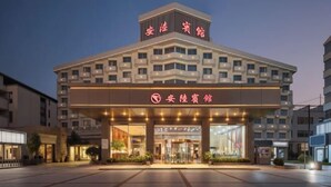 Un hotel de diseño moderno, con una entrada destacada que cuenta con puertas de cristal y un cartel sobre la entrada.