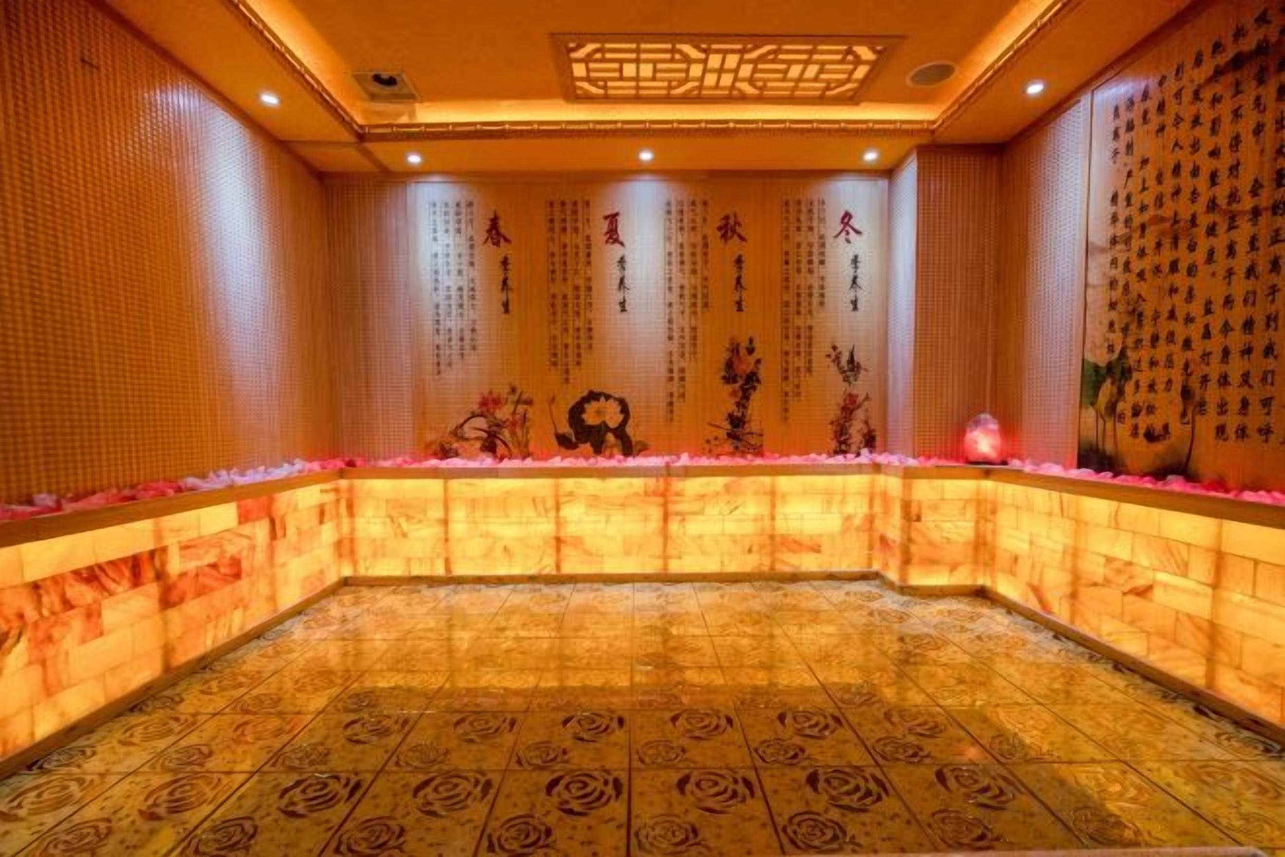 A room with a patterned floor, a reception desk, and decorative wall elements.