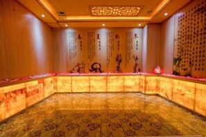 A room with a patterned floor, a reception desk, and decorative wall elements. - Gujiang Hotel (Dahua)