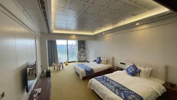 A hotel room with two beds, a large window, a ceiling with a grid pattern, and a view of the outdoors.
