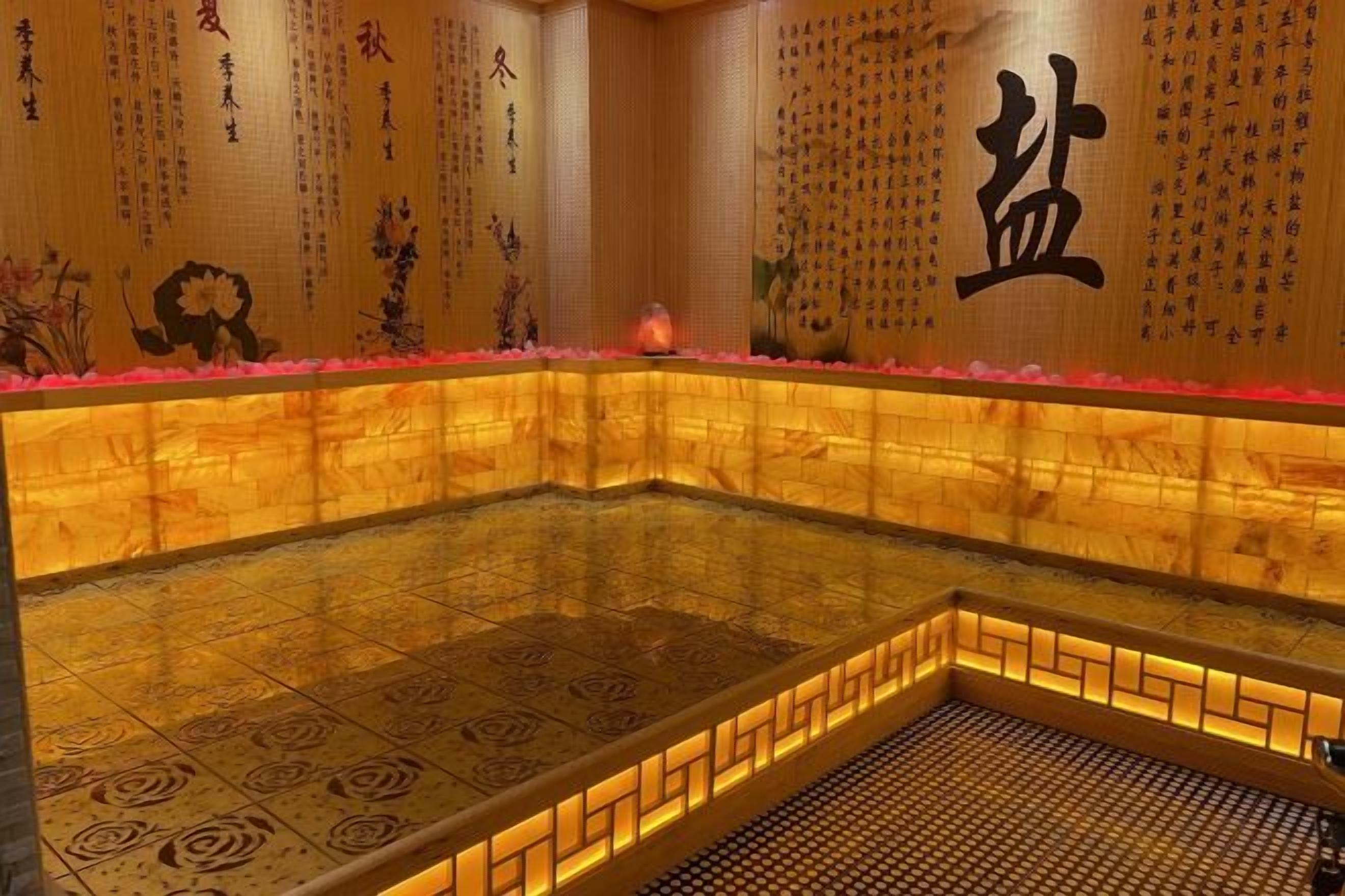 A traditional Japanese onsen with a tiled floor, wooden walls, and a tiled ceiling.