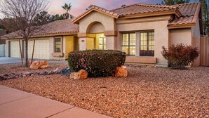 A two-story house with a tiled roof, a front entrance, and a driveway. - Arrowhead Family Getaway Pool Pet Friendly (Peoria)